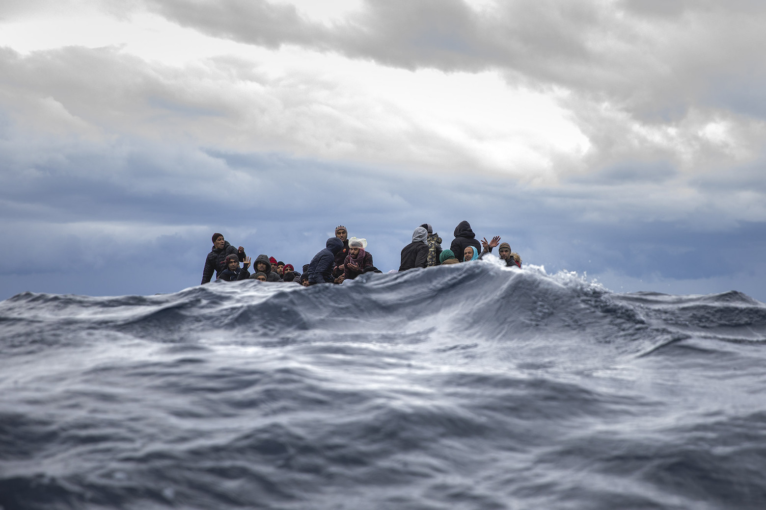 Ein überfülltes Holzboot mit Migranten, die von Libyen losgefahren sind